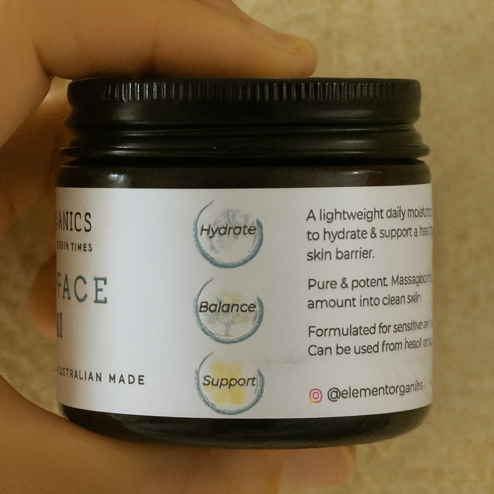 Side View. Element Organics Tallow Face Cream in an an amber lass jar with a label.
