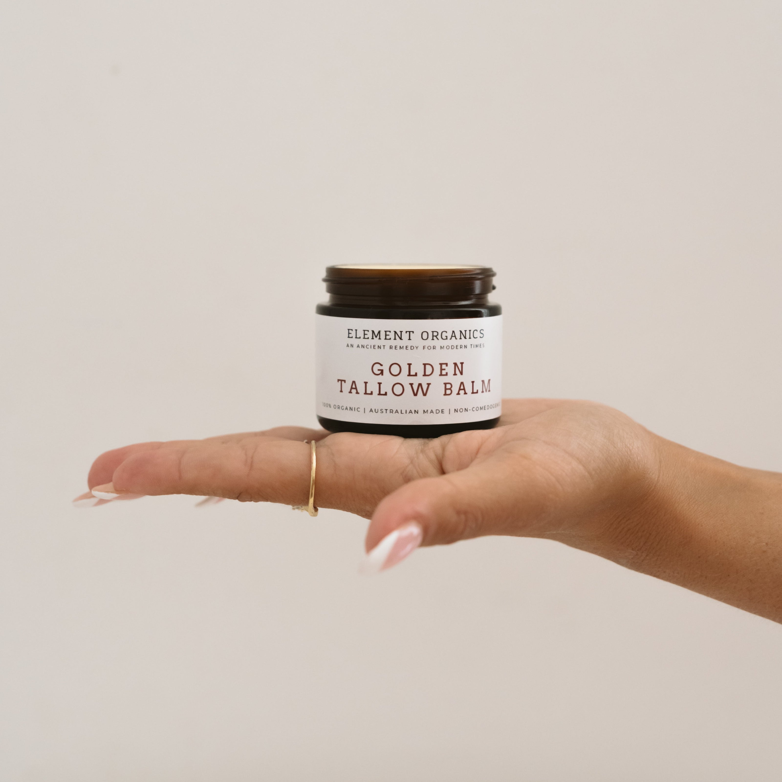 Tallow skincare sitting on a girls palm