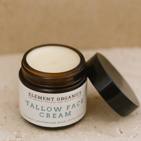 Jar of Element Organics Tallow Face Cream on a beige surface with a neutral background